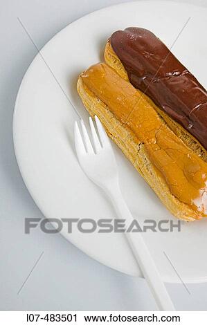 Chocolate and coffee eclairs with fork. Paris. France View Large Photo Image Stock Image - Chocolate and coffee eclairs with fork. Paris. France. Fotosearch