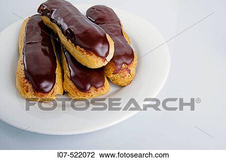 Chocolate? clairs on a white plate View Large Photo Image Stock Image - Chocolate? clairs on a white plate. Fotosearch