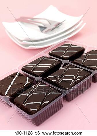 Chocolate mud cake slices isolated against a pink background View Large Photo Image Stock Photograph - Chocolate mud cake slices isolated against a pink background. Fotosearch
