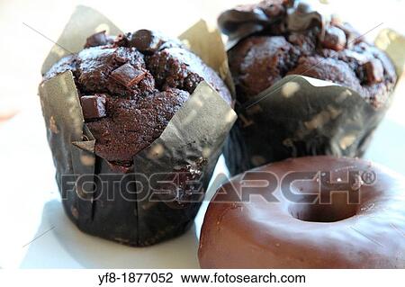 Chocolate muffins and doughnuts on plate View Large Photo Image Stock Image - Chocolate muffins and doughnuts on plate. Fotosearch
