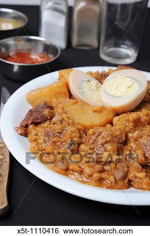 Cholent or hamin is a traditional Jewish stew simmered overnight, for 12 hours or more, and eaten for lunch on the Sabbath View Large Photo Image Stock Photograph - Cholent or hamin is a traditional Jewish stew simmered overnight, for 12 hours or more, and eaten for lunch on the Sabbath. Fotosearch
