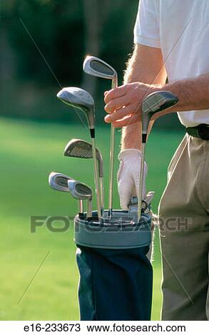 Choosing golf clubs View Large Photo Image Stock Image - Choosing golf clubs. Fotosearch