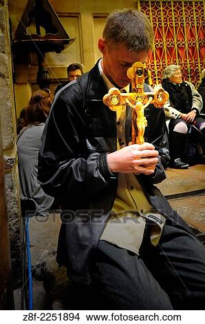 Picture - Christian worshippers holding a cross in the Church of the Holy Sepulchre during the Good Friday procession in Jerusalem's Old City.. Fotosearch