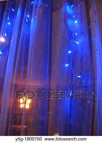 christmas lights hanging on shop window at night View Large Photo Image Stock Image - christmas lights hanging on shop window at night. Fotosearch