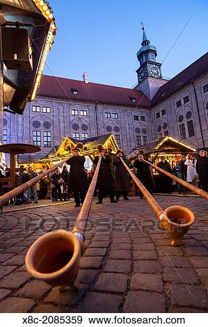 Christmas market in Munich. The alpine Christmas Village in the Kaiserhof of the Residenz, the palace of the bavarian kings. Concert with Alpenhorn (Alphorn). Europe, Germany, Bavaria, Munich, December 2013. View Large Photo Image Stock Photo - Christmas market in Munich. The alpine Christmas Village in the Kaiserhof of the Residenz, the palace of the bavarian kings. Concert with Alpenhorn (Alphorn). Europe, Germany, Bavaria, Munich, December 2013.. Fotosearch