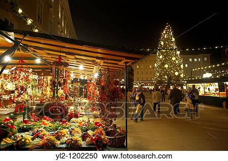 Stock Image - Christmas market stalls at night with Christams lights at Satlzburgh market - Austria. Fotosearch
