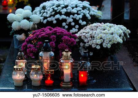 Chrysanthemums and candles on Wolski cemetery in Warsaw, Poland during All Saints Day View Large Photo Image Stock Photography - Chrysanthemums and candles on Wolski cemetery in Warsaw, Poland during All Saints Day. Fotosearch