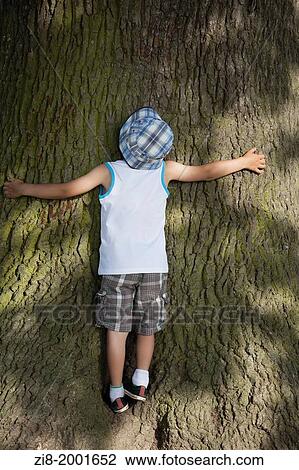 Chuld hugs a tree. View Large Photo Image Stock Image - Chuld hugs a tree.. Fotosearch