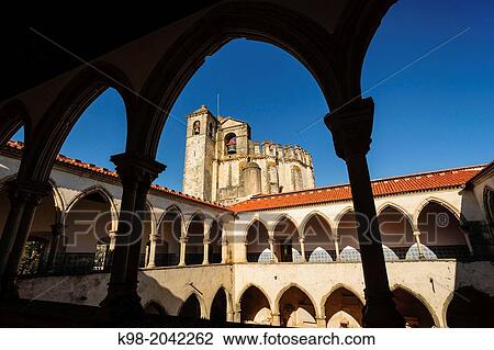 Stock Image - church framed by the upper arches of the cloister Do Cemiterio, Convent of Christ, year 1162, Tomar, District of Santarem, Medio Tejo, region center, Portugal, Europe.. Fotosearch