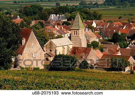 Stock Image - Church of Saint Martin founded in 1172 and surrounded by the best wines of the village as Domaine Napoleon, Fixin, C? te de Nuits, C? te d? Or, Burgundy, France. Fotosearch