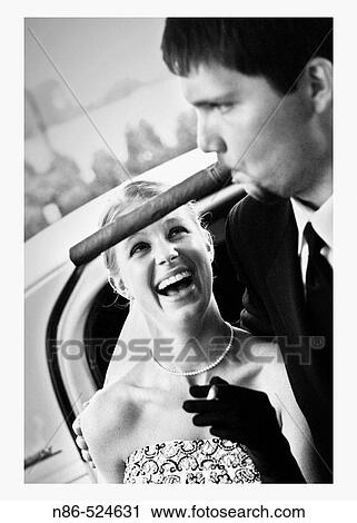 Cigar smooking groom and bride View Large Photo Image Stock Image - Cigar smooking groom and bride. Fotosearch