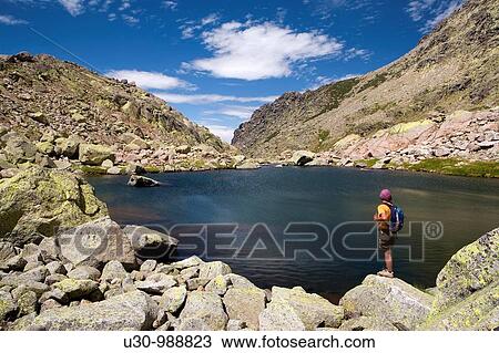 Stock Image - Cinco Lagunas Valley Garganta del Pinar Woman practice mountaineering in the mountains of the Sierra de Gredos National Park Zapardiel de la Ribera? vila Castilla y Le? n Spain. Fotosearch