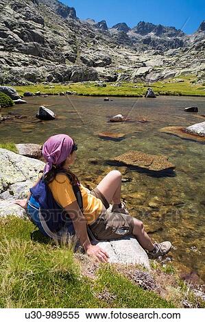 Stock Photography - Cinco Lagunas Valley Garganta del Pinar Woman practice mountaineering in the mountains of the Sierra de Gredos National Park Zapardiel de la Ribera? vila Castilla y Le? n Spain. Fotosearch
