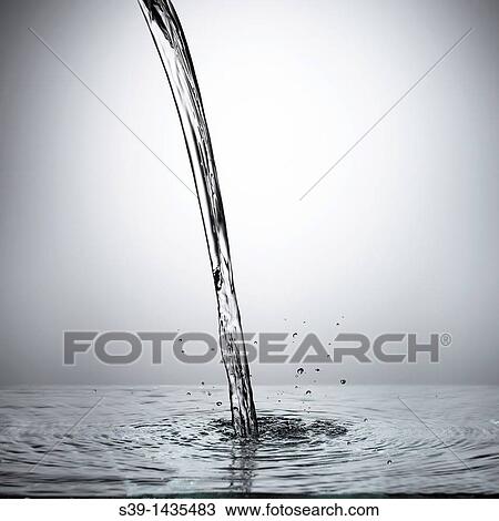 Stock Image - Circle of falling water and splash with a gray background. Fotosearch