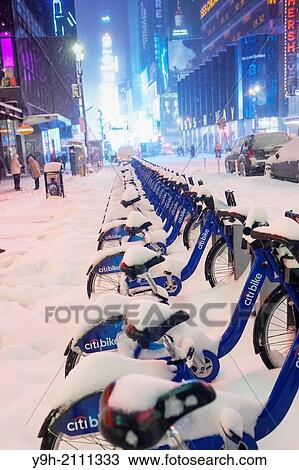 CitiBikes in Times Square in New York covered in snow during a snow storm View Large Photo Image Stock Image - CitiBikes in Times Square in New York covered in snow during a snow storm. Fotosearch