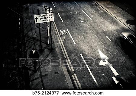 City road with traffic and a man walking at night in the direction of Westminster Southwark Bridge, London, England, UK View Large Photo Image Stock Photo - City road with traffic and a man walking at night in the direction of Westminster Southwark Bridge, London, England, UK. Fotosearch