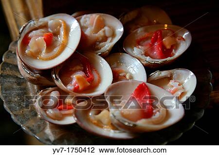 Stock Image - Clams in one of the most famous wine taverns of Malaga? The Old Home of the Guard? Malaga, Andalusia, Spain. Fotosearch