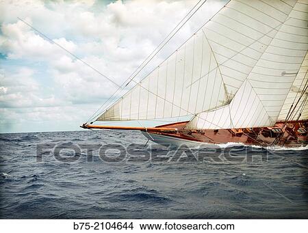 Classic sailboat in a regatta with sailors in the background at the Mediterranean sea, Menorca, Balearic Islands, Spain. View Large Photo Image Picture - Classic sailboat in a regatta with sailors in the background at the Mediterranean sea, Menorca, Balearic Islands, Spain.. Fotosearch