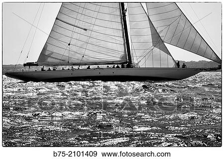 Classic sailboat in a regatta with sailors in the background at the Port Mahon, Menorca, Balearic Islands, Spain. View Large Photo Image Stock Photo - Classic sailboat in a regatta with sailors in the background at the Port Mahon, Menorca, Balearic Islands, Spain.. Fotosearch