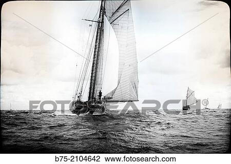 Classic sailboats in a regatta with sailors in the background at the Mediterranean sea, Menorca, Balearic Islands, Spain. View Large Photo Image Stock Image - Classic sailboats in a regatta with sailors in the background at the Mediterranean sea, Menorca, Balearic Islands, Spain.. Fotosearch