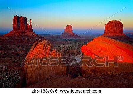 Classic view of the Mittens and Merrick Butte in Monument Valley, AZ View Large Photo Image Stock Photograph - Classic view of the Mittens and Merrick Butte in Monument Valley, AZ. Fotosearch