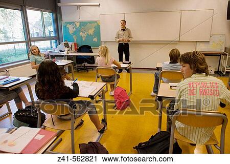 Stock Image - Classroom with students and teacher. Fotosearch