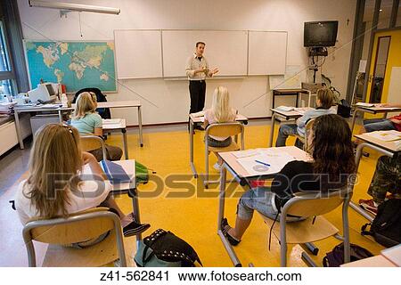Stock Image - Classroom with students and teacher. Fotosearch
