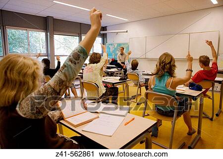 Stock Image - Classroom with students and teacher. Fotosearch