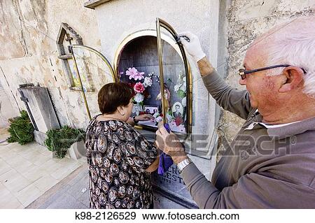 cleaning a family altar,, Cemetery Porreres, Commemoration of the Faithful Departed, popularly called Dia de Muertos or Day of the Dead, Mallorca, Balearic Islands, Spain. View Large Photo Image Stock Photo - cleaning a family altar,, Cemetery Porreres, Commemoration of the Faithful Departed, popularly called Dia de Muertos or Day of the Dead, Mallorca, Balearic Islands, Spain.. Fotosearch