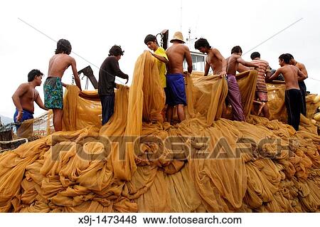 Cleaning fishing nets, Langkawi Island, Kedah, Malaysia. View Large Photo Image Stock Photo - Cleaning fishing nets, Langkawi Island, Kedah, Malaysia.. Fotosearch