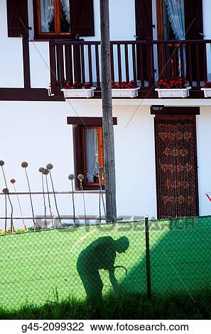 Stock Image - Cleaning the garden, Hondarribia, Basque Country.. Fotosearch