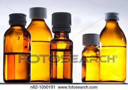 Stock Image - Clear bottles with liquid drugs. Fotosearch