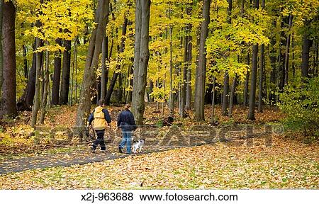 Cleveland, Ohio - A couple walks with their dog on a trail in the Rocky River Reservation Metropark View Large Photo Image Stock Photo - Cleveland, Ohio - A couple walks with their dog on a trail in the Rocky River Reservation Metropark. Fotosearch