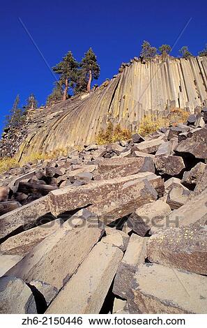 Stock Photograph - Cliff and blocks of columnar basalt at Devils Postpile, Devils Postpile National Monument, California USA.. Fotosearch