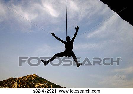Stock Image - Climber hanging from rope. Bentu? de Rasal. Huesca province, Arag? n. Spain. Fotosearch