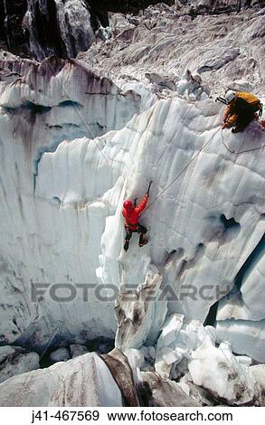 Climber on steep ice face. Fox glacier crevasses near Victoria Falls. Westland National Park. South Island. New Zealand. View Large Photo Image Stock Photo - Climber on steep ice face. Fox glacier crevasses near Victoria Falls. Westland National Park. South Island. New Zealand.. Fotosearch