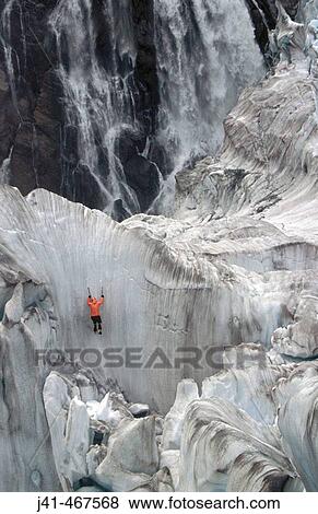 Climber on steep ice. Fox glacier crevasses near Victoria Falls. Westland National Park. South Island. New Zealand. View Large Photo Image Stock Photo - Climber on steep ice. Fox glacier crevasses near Victoria Falls. Westland National Park. South Island. New Zealand.. Fotosearch