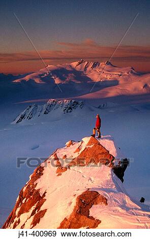 Climber on summit at sunset above Franz Josef Glacier. Westland National Park. New Zealand View Large Photo Image Stock Photo - Climber on summit at sunset above Franz Josef Glacier. Westland National Park. New Zealand. Fotosearch