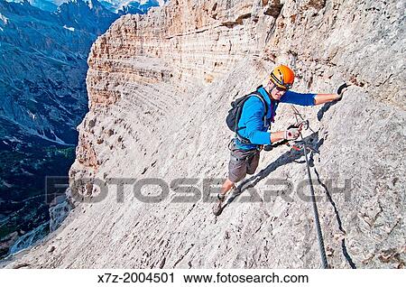 climbing the Giovanni Lipella via ferrata on Tofana De Rozes in the Dolomite Mountains near the city of Cortina in northern Italy. View Large Photo Image Stock Image - climbing the Giovanni Lipella via ferrata on Tofana De Rozes in the Dolomite Mountains near the city of Cortina in northern Italy.. Fotosearch