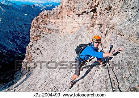 climbing the Giovanni Lipella via ferrata on Tofana De Rozes in the Dolomite Mountains near the city of Cortina in northern Italy. View Large Photo Image Stock Photo - climbing the Giovanni Lipella via ferrata on Tofana De Rozes in the Dolomite Mountains near the city of Cortina in northern Italy.. Fotosearch
