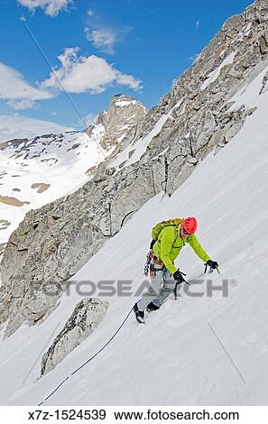 Stock Photo - Climbing the Vertical Perceptions Couloir on the North Face of Cobb Peak in the Pioneer Mountians of central Idaho. Fotosearch