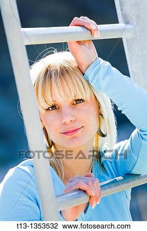 Stock Image - Climbing young woman portrait. Fotosearch