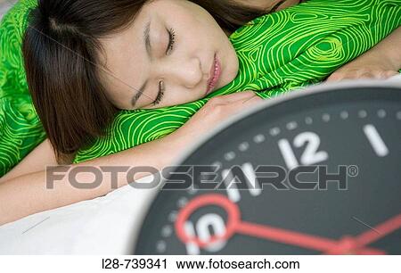 clock, a young woman is sleeping in bed View Large Photo Image Stock Image - clock, a young woman is sleeping in bed. Fotosearch