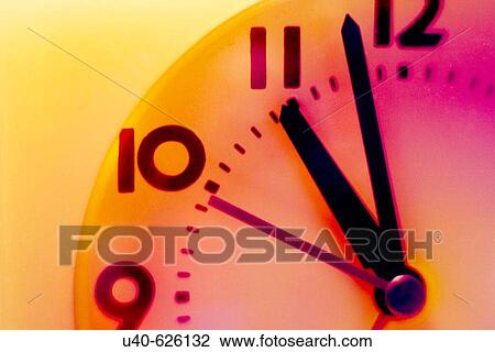 Stock Image - Clock hands showing 11: 00. Fotosearch
