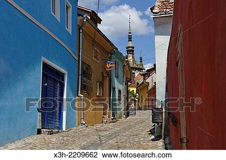 Stock Image - Clock Tower seen from south path leading into Old Town, Sighisoara, Transylvania, Romania, Southeastern and Central Europe.. Fotosearch