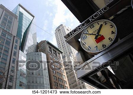 Stock Image - Clock with Hong Kong Time in New York. Fotosearch