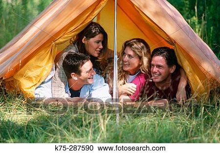 Stock Image - close friends in a small tent. Fotosearch