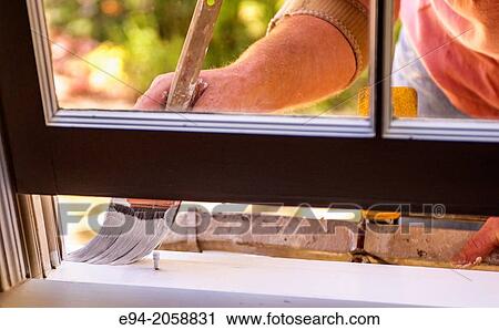 Close in detail of a 41 year old man painting the window trim of a house facing inside. View Large Photo Image Stock Image - Close in detail of a 41 year old man painting the window trim of a house facing inside.. Fotosearch