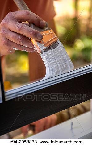 Close in detail of a 41 year old man painting the window trim of a house facing inside. View Large Photo Image Stock Image - Close in detail of a 41 year old man painting the window trim of a house facing inside.. Fotosearch