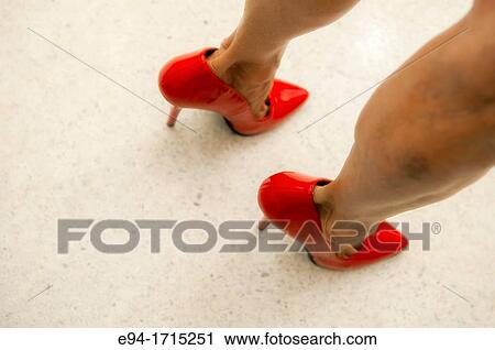 Close shot of a woman's legs with red high heels View Large Photo Image Stock Image - Close shot of a woman's legs with red high heels. Fotosearch